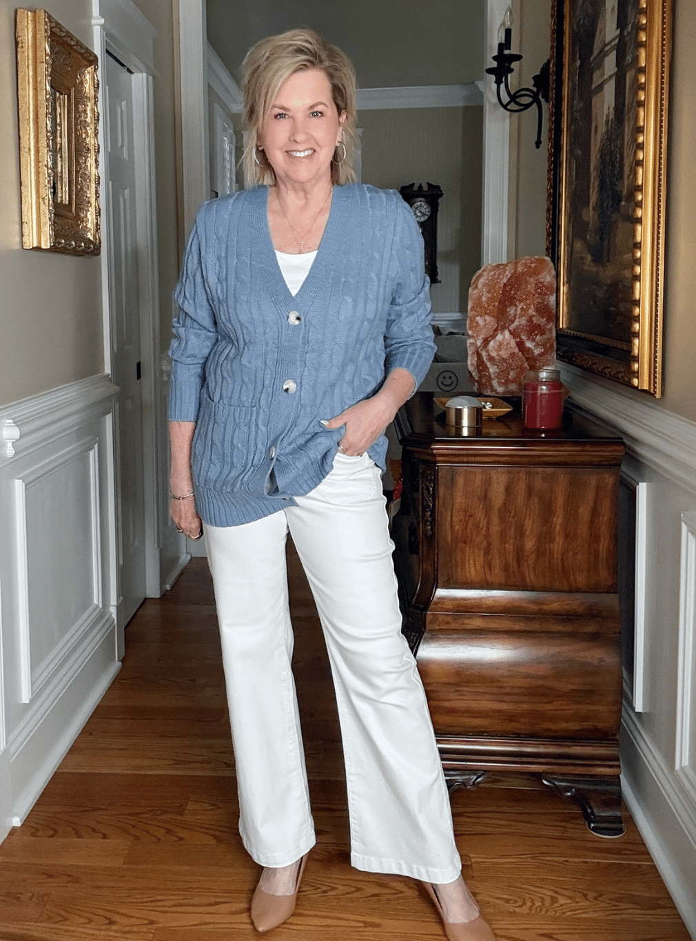 Tania Stephens is wearing a pair of white jeans and a blue cardigan from Amazon